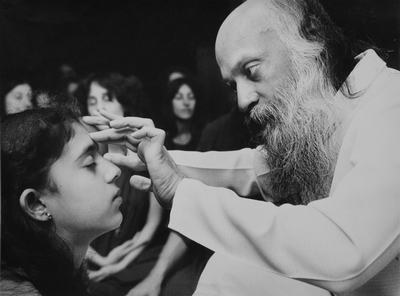 Ma Deva Priya as child taking energy darshan from Osho
